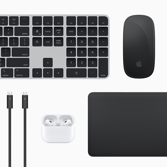 Top view of Mac accessories: Magic Keyboard, Magic Mouse, Magic Trackpad, AirPods and Thunderbolt cables